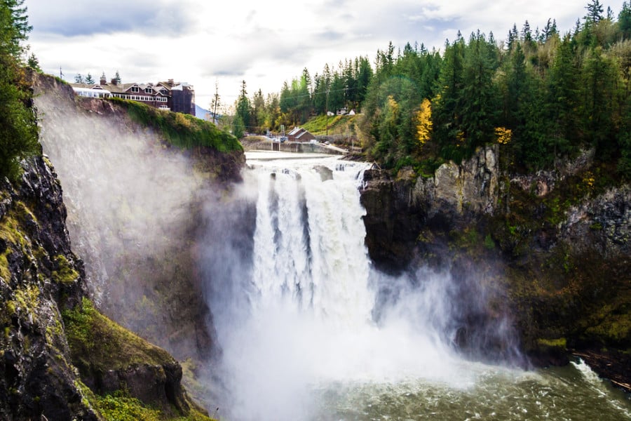 Stunning Snoqualmie Falls below the buildings in the mountain of Washington during autumn