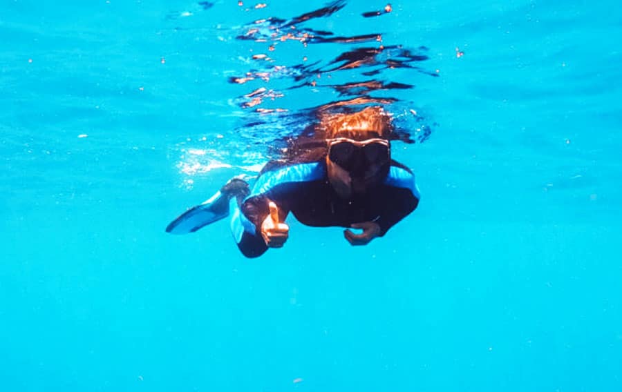 The author's wife snorkeling under the blue water of Fort Lauderdale