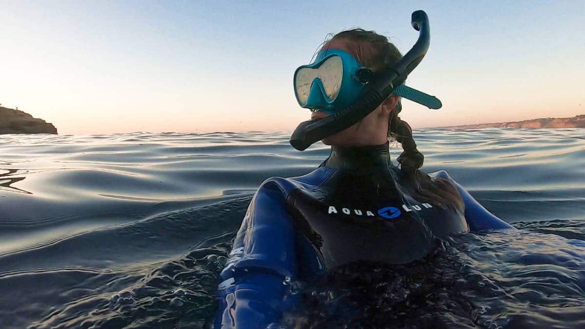 The author Ashleigh Bandimere on a full gear snorkeling suit in Playa Hermosa at sunset