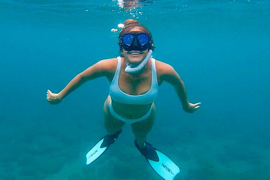 The author's wife snorkeling under the blue water of St. John