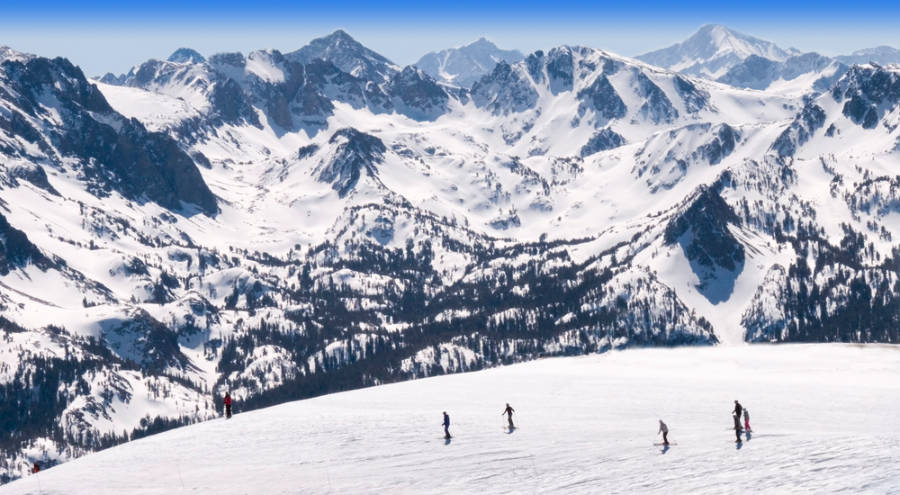 View of the skiers with a scenic view of the snow-covered mountain in the background