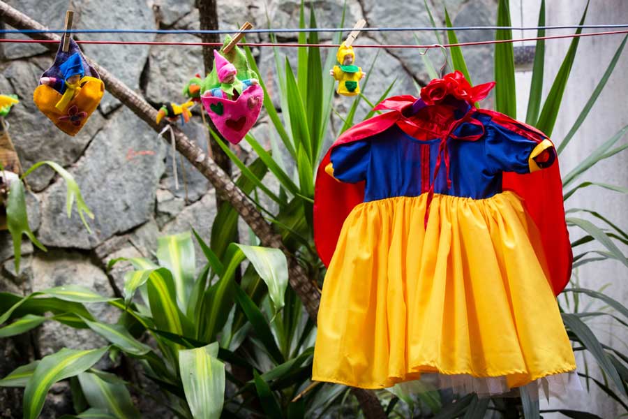 A small Snow White costume hanging outside