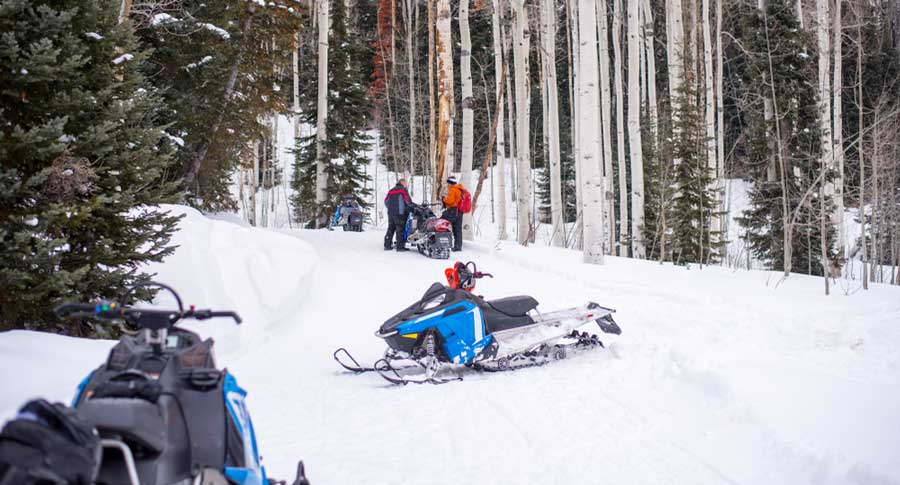 People snowmobiling in Telluride during winter season
