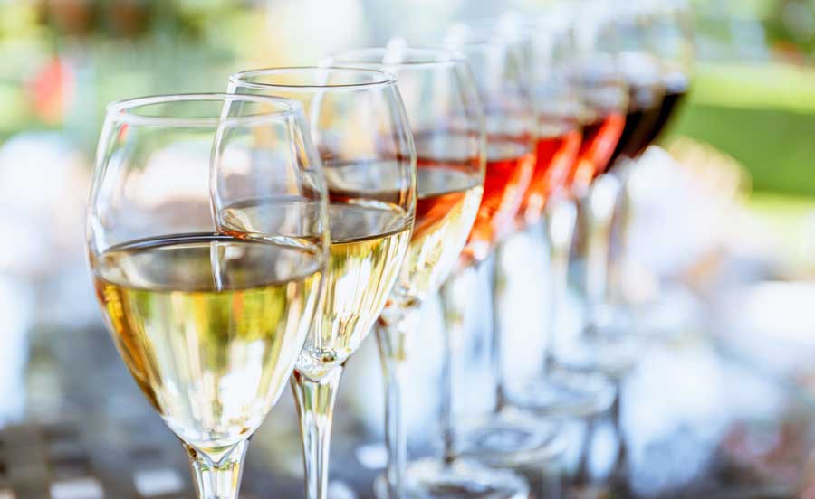 Different kinds of wine lined on a table