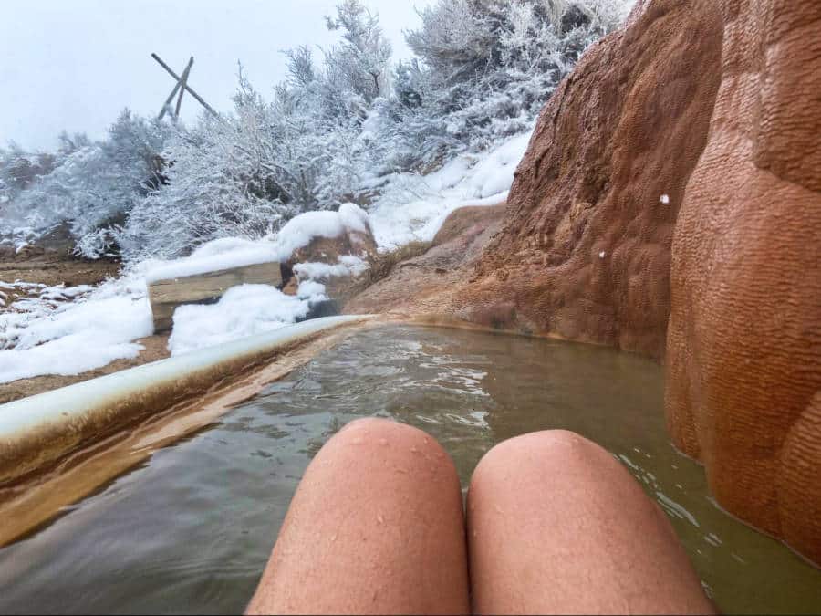 View of the legs while soaking in the Mystic Hot Springs in winter