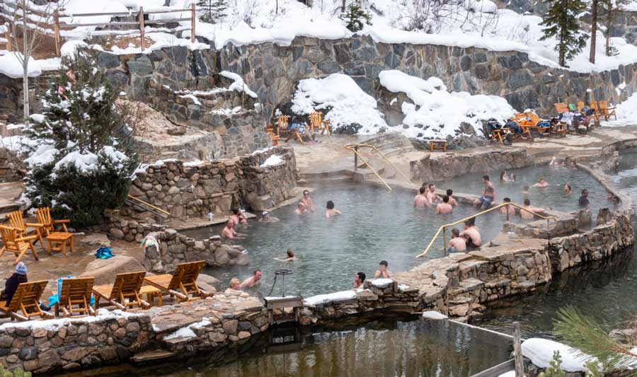 View of people soaking in Strawberry Park Hot Springs during winter season
