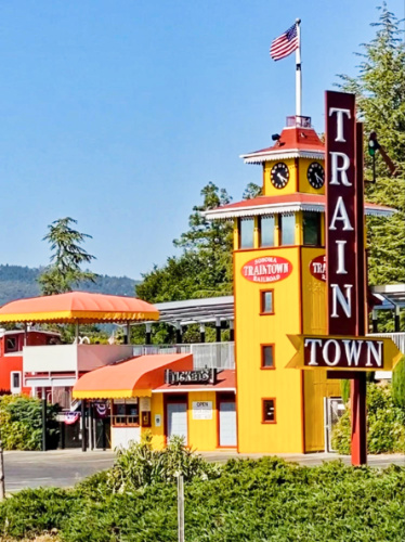 Exterior view of the vibrant yellow Sonoma TrainTown Railroad from a distance