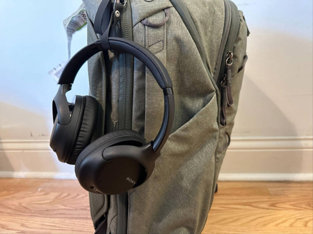 A Sony headphones hanging on a backpack