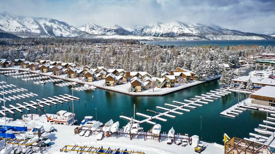 Aerial view of the snow covered cabins and mountain in South Lake Tahoe during winter