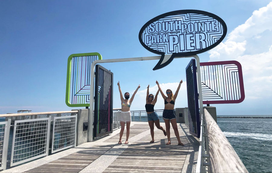 View of three women posing for a picture in South Pointe Park Pier