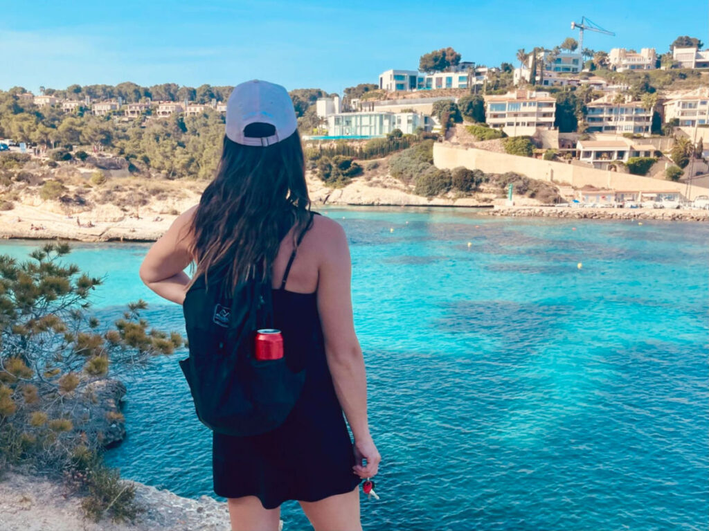 Travel Lemming writer Betty in black dress admiring the water on Spain's southern coast