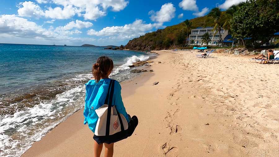 A woman walking by the beach in Limetree Beach