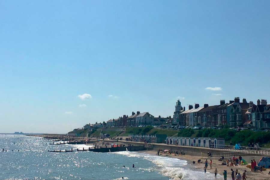 People enjoying their day under the clear blue sky in Southwold beach