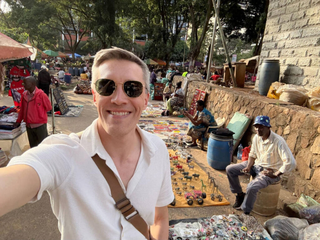 The author Nate Hake taking a selfie at a souvenir market near the Ministry of Education