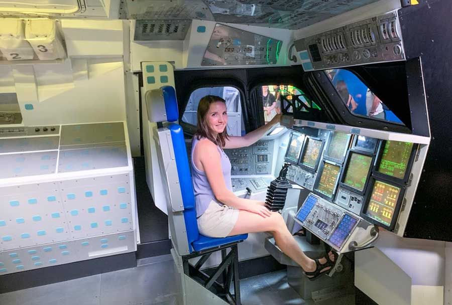The author sitting on the space shuttle Control replica in Kennedy Space Center Visitor Complex