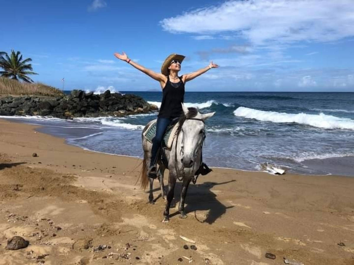 A woman horseback riding in Spanish Wall Beach