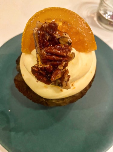 A plate with spiced date cake topped with candied orange from Ottolenghi