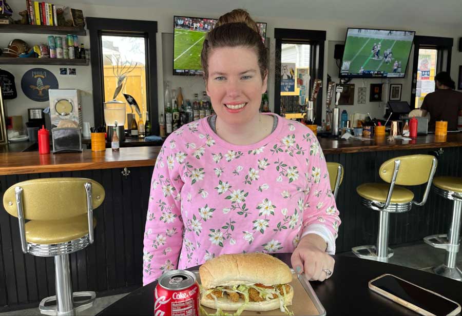 The author enjoying her shrimp poboy and a canned coke in Spicy Boy's
