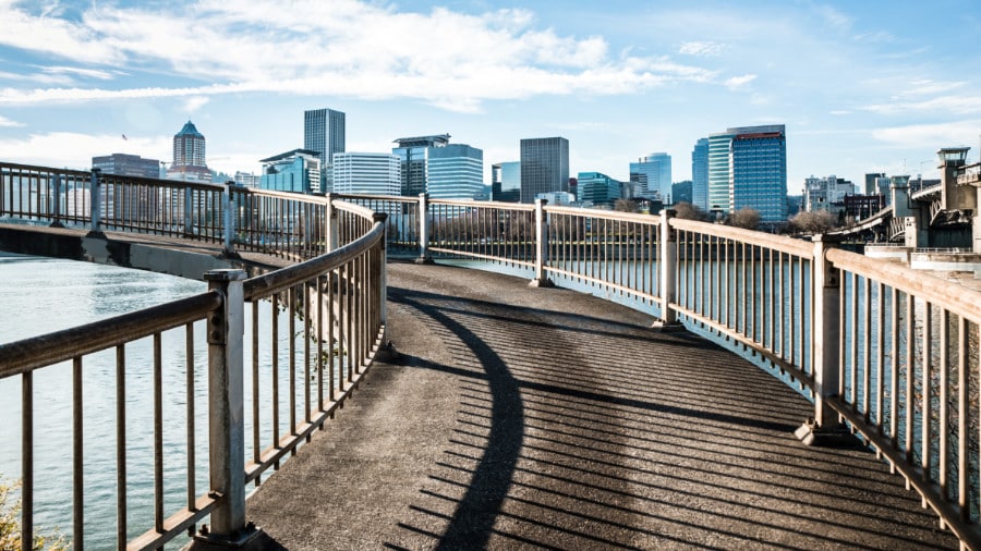 A bridge over the Willamette River with Portland skyline view