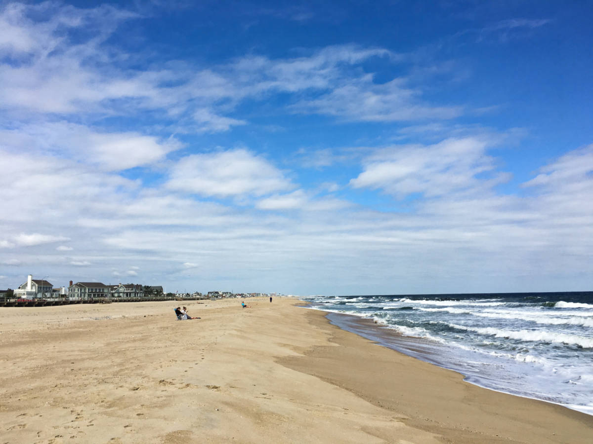 Few beach goers enjoying the beautiful sunny day in Spring Lake's white sand beach