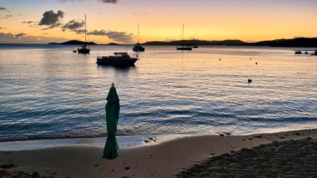 View of the boats sailing from St Thomas’s Secret Harbour beach at sunset