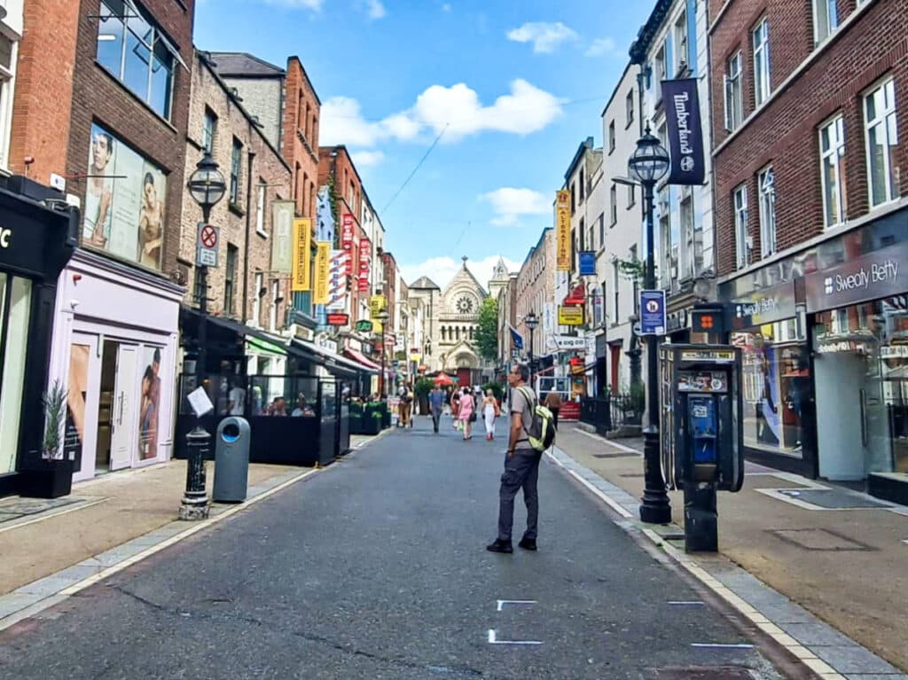 View of the St. Ann’s Cathedral from the busy street of Grafton
