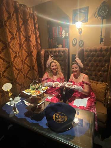 The author with her friend sitting on a couch inside The St. James Tearoom