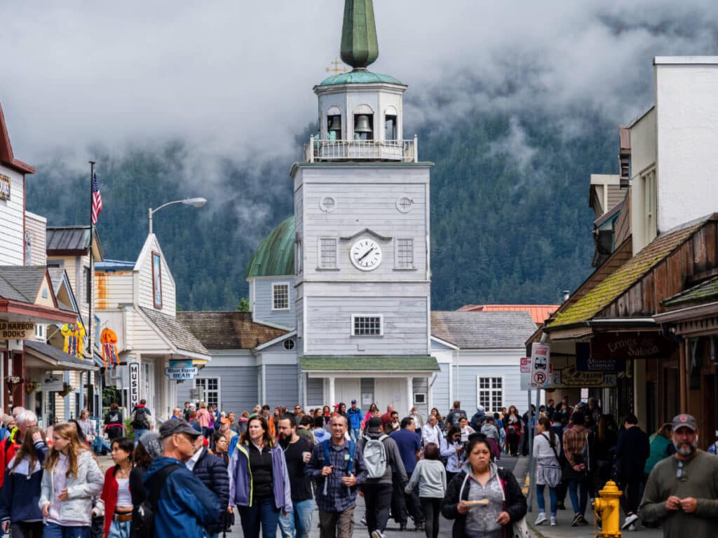 View of people at downtown Sitka and the St. Michael’s Cathedral on the background