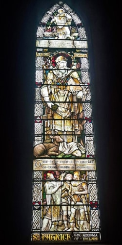 Closeup view of the details of stained glass depiction of St. Patrick inside the St. Patrick’s Cathedral