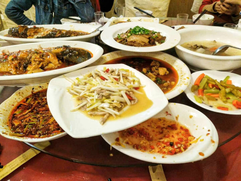 Stack of dishes on the table at a family style meal in Chengdu
