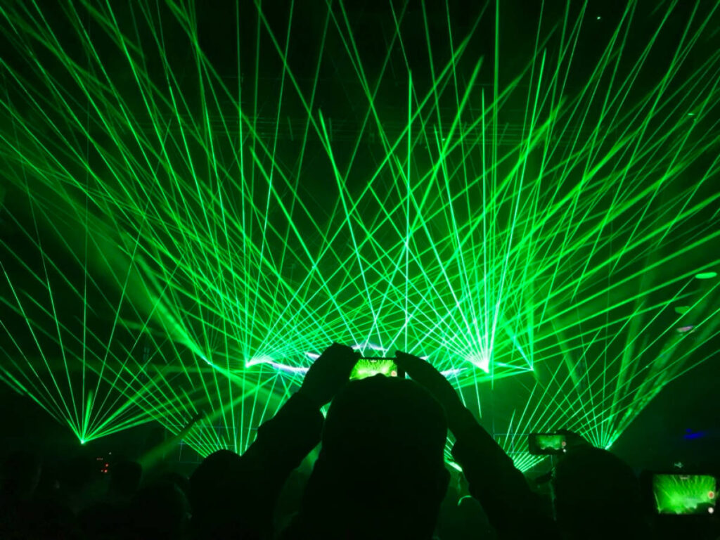 People capturing an image of the green laser lights