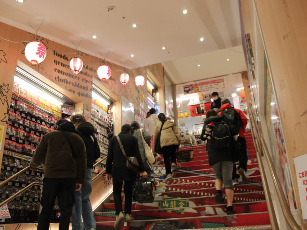 People going up using a stairs at the Don Quixote
