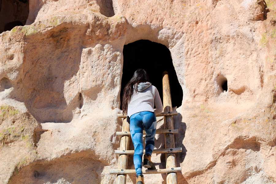 The author climbing a wooden stair in Bandelier National Monument