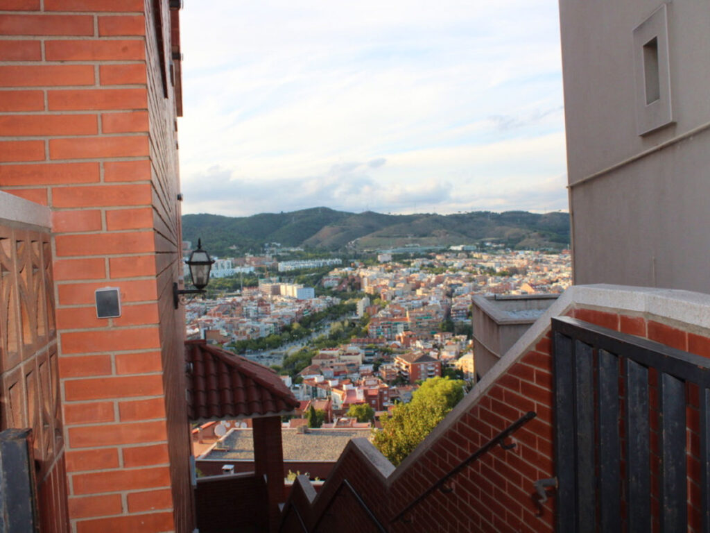 View of the city from the top of a staircase in uphill Gràcia district