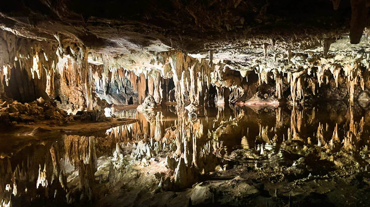 View of the stalactites reflecting on the water inside the cavern in Luray