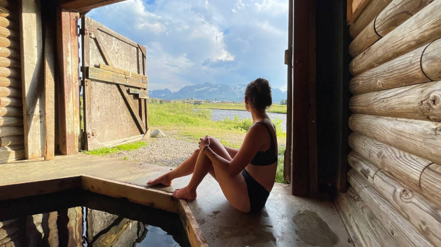 The author Taylor Ramsey, enjoying the magnificent mountain view and river at the hot spring of Mountain Village Resort in Stanley