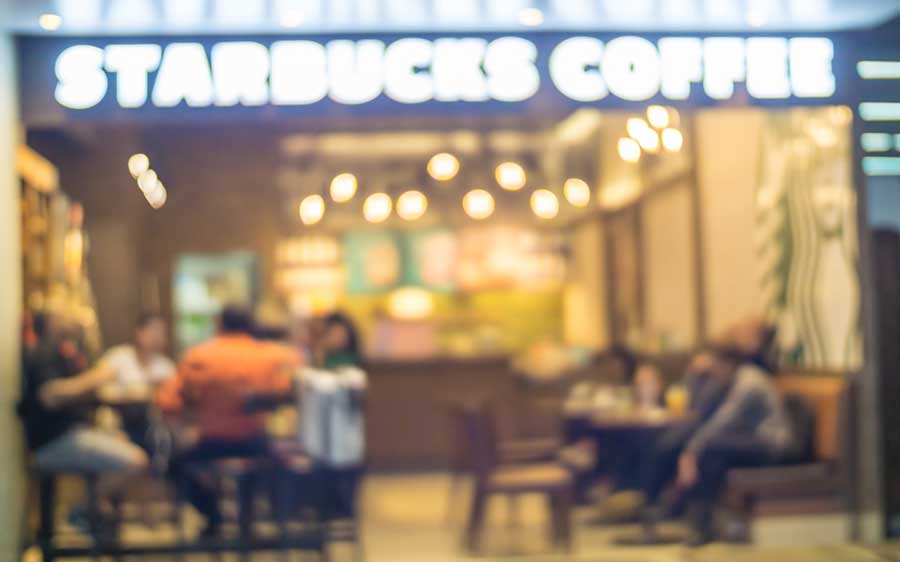 A blurred photo of people enjoying their drinks from the Starbucks Coffee shop