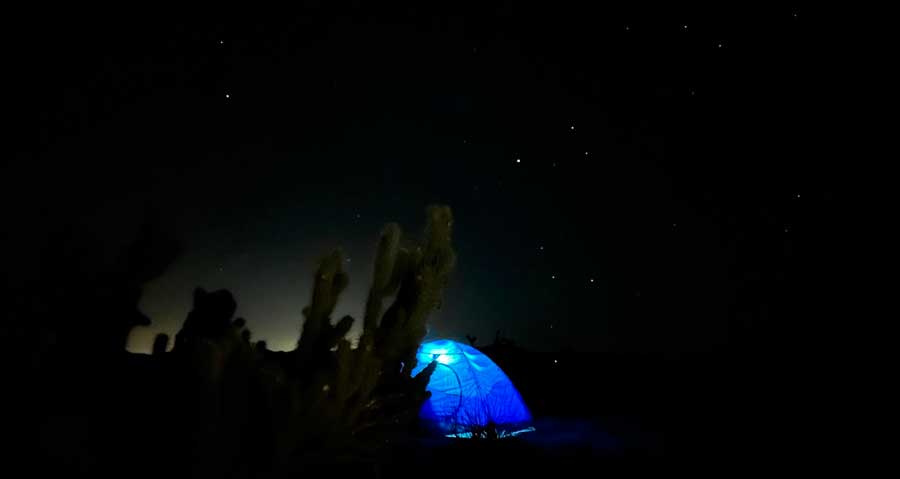 A camping tent with lights at night in Anza Borrego
