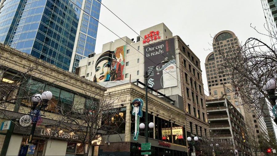 A mural on the exterior of the State Hotel with skyscrapers around