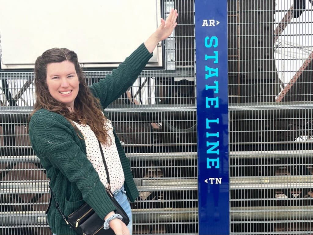 The author, Elizabeth Demolat posing for a photo with the State Line in Memphis