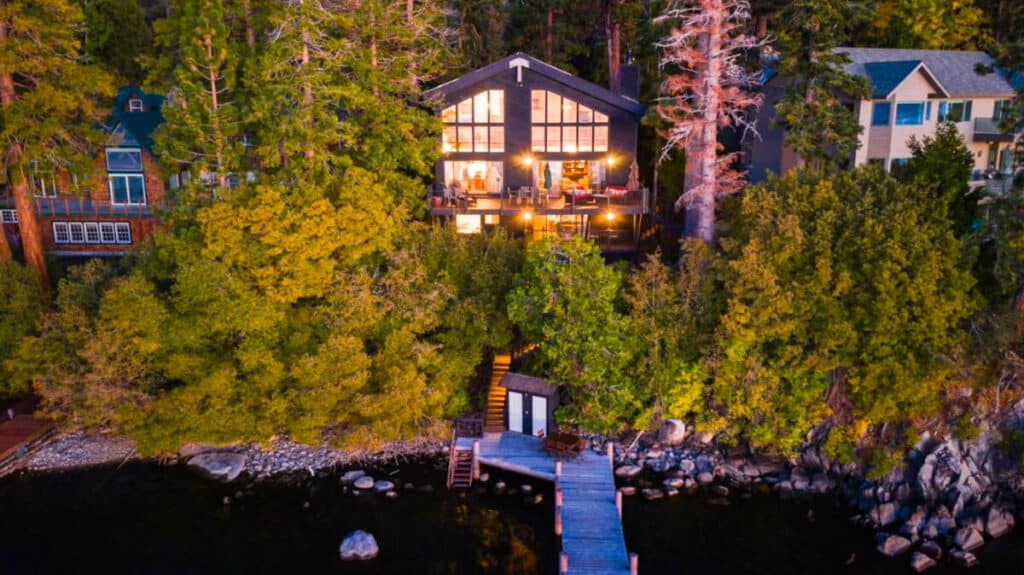 Aerial view of the illuminated cabin with a boardwalk along the lake