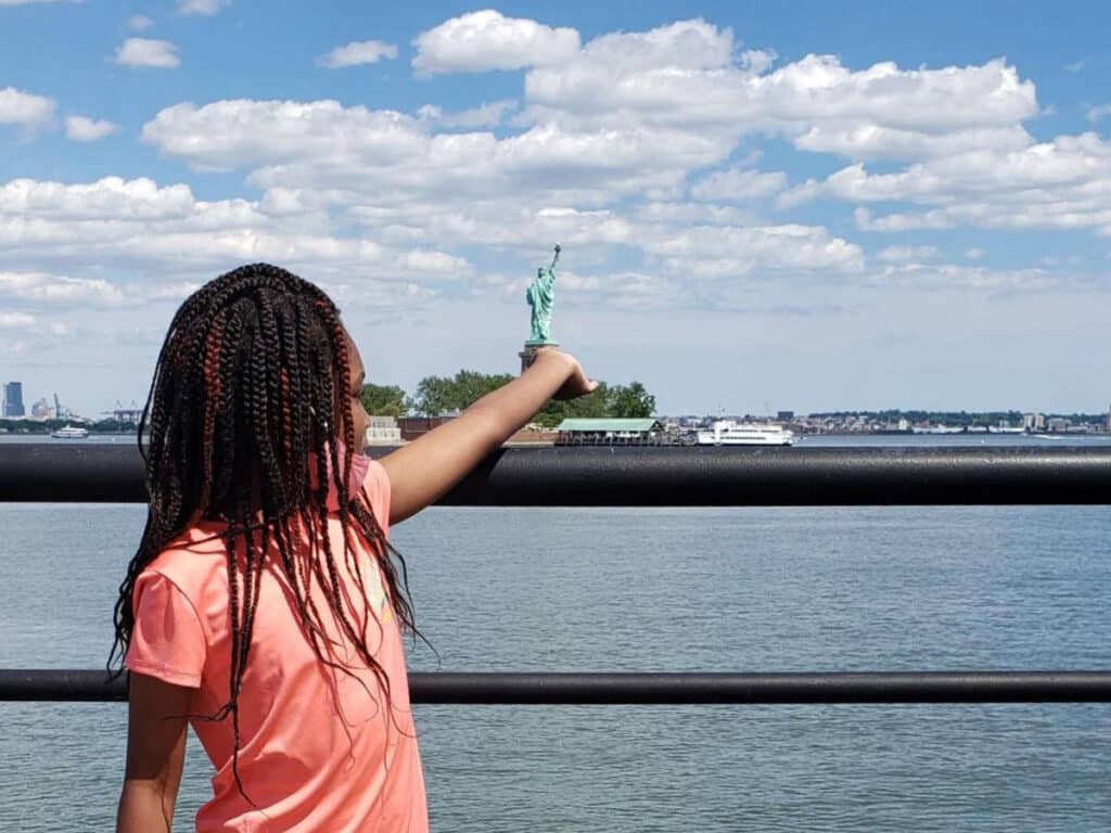 The author's daughter holding the Statue of Liberty at Liberty State Park