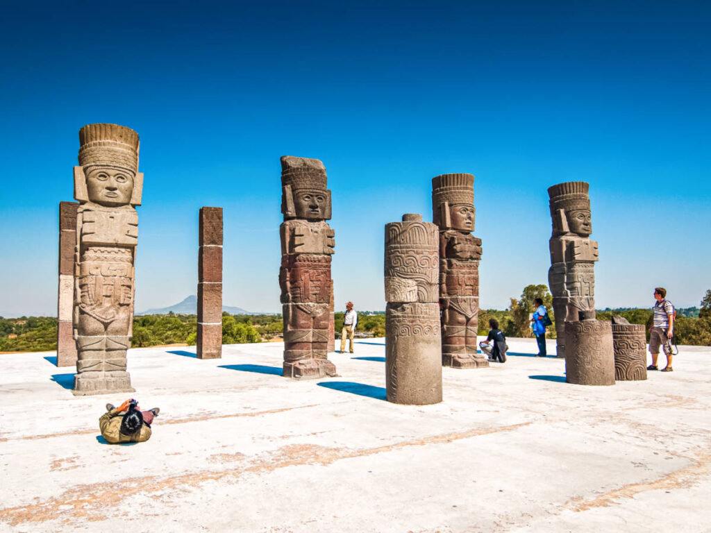 People looking at the prehispanic statues at Tula De Allende