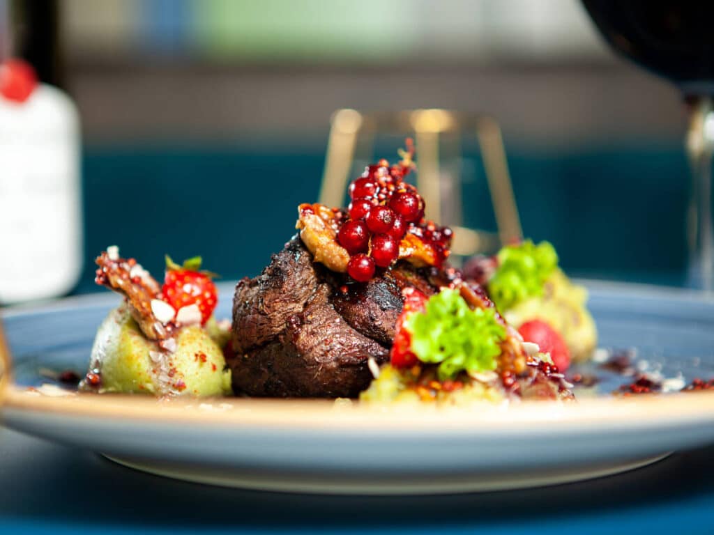 A grilled steak served on a plate in Delila