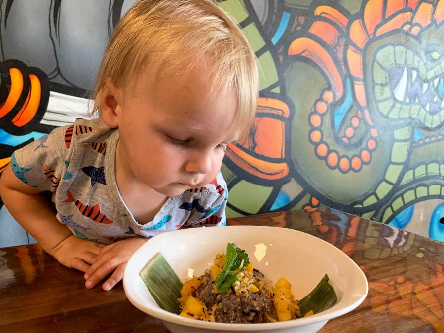 The author's son looking at his favorite mango and sticky rice desserts
