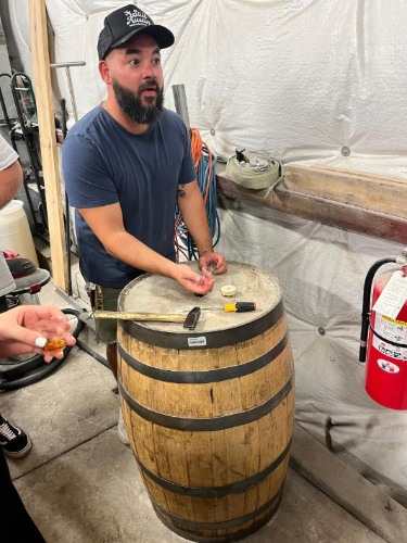 A man explaining things during a tour in Still Austin Whiskey Co.