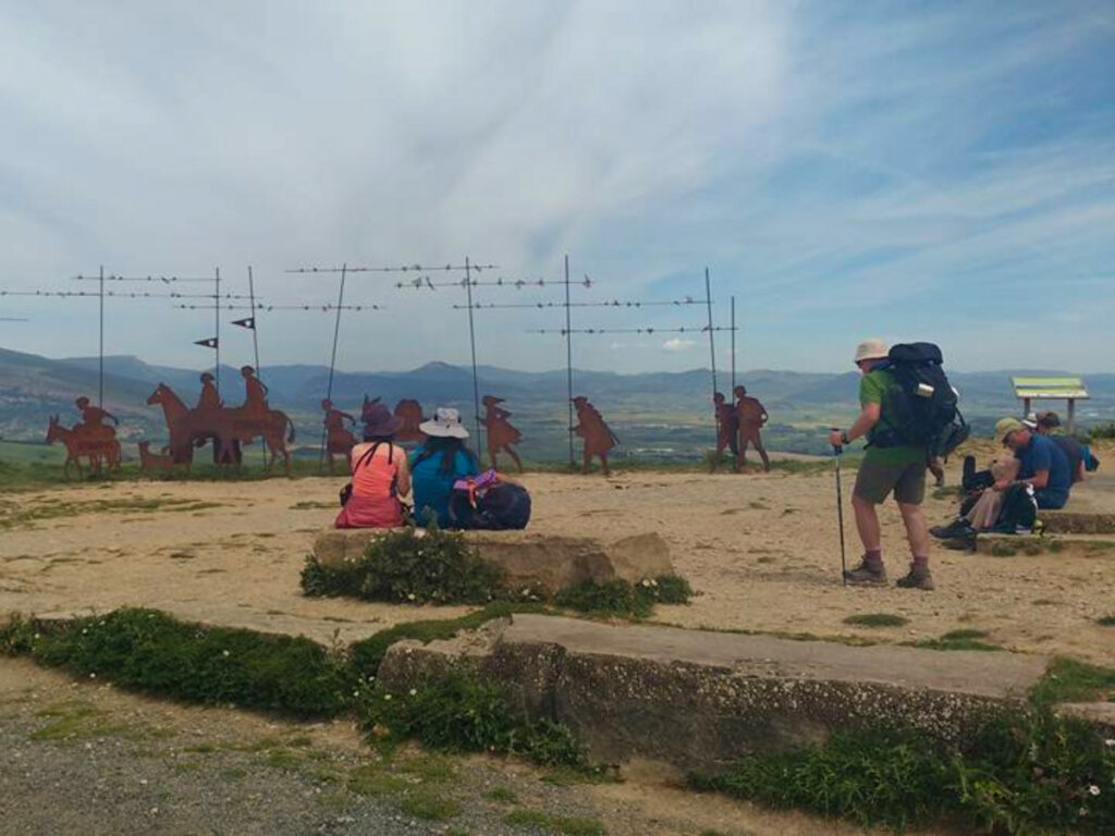 A group of hikers resting at Alto de Perdón.