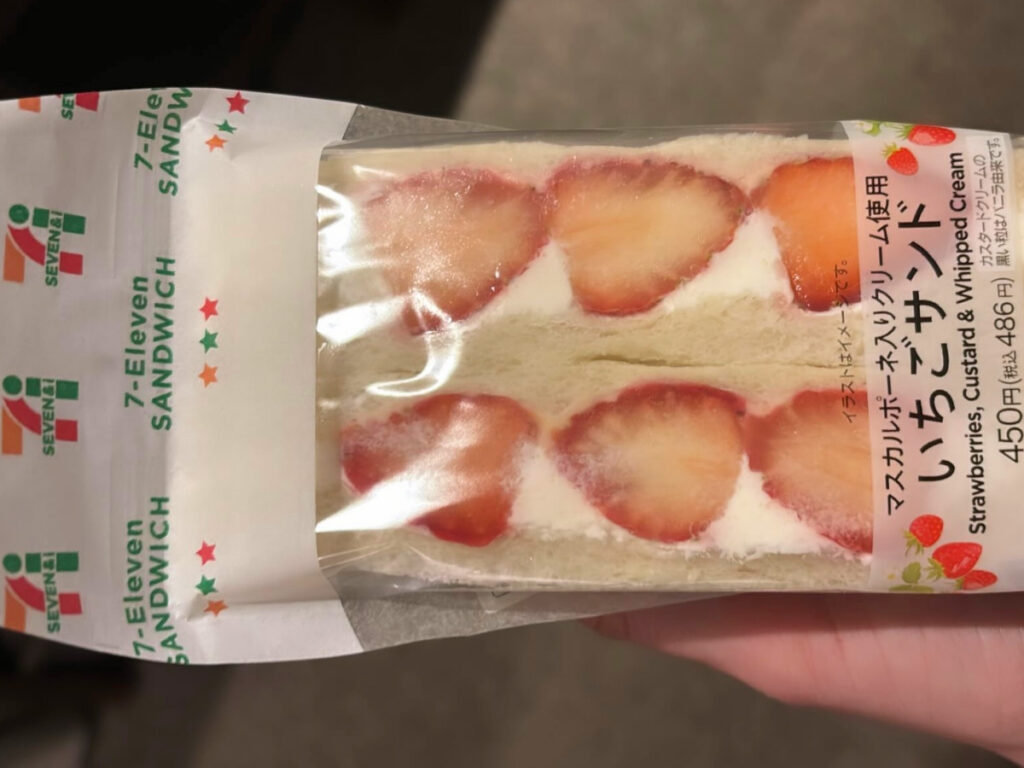 Author Sky Ariella holding the viral Japanese strawberry sandwich from 7-11
