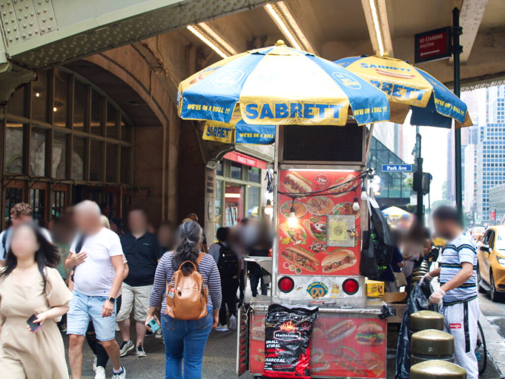 View of the passerby in front of the street food cart in Manhattan