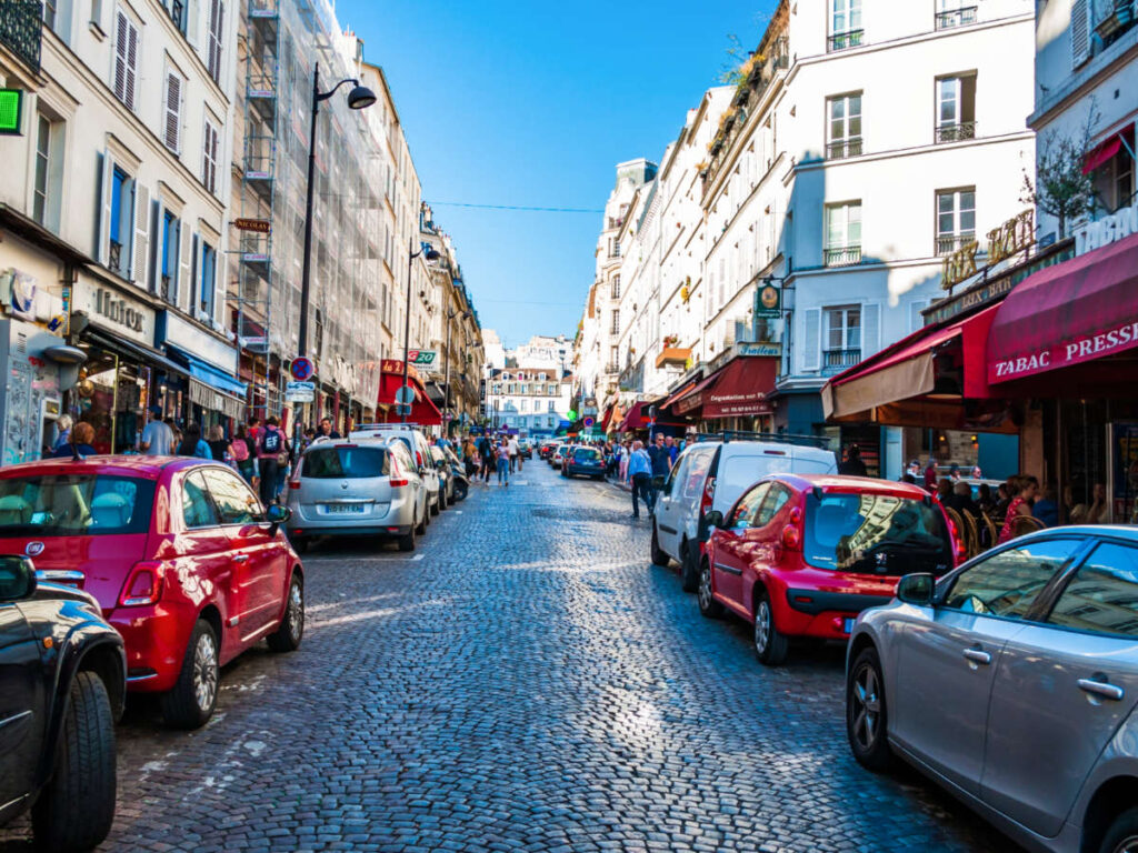 View of the cars parked along the street in Paris